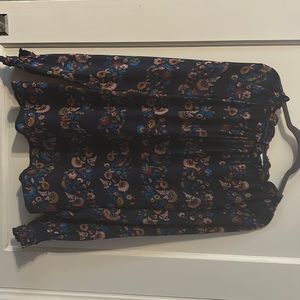 100% silk navy floral Boden blouse with ruffle detail and smocked cuffs.